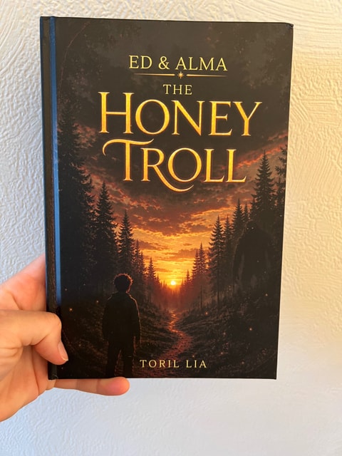 A real copy of The Honey Troll held in a reader's hand